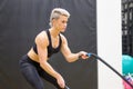 Muscular sporty middle-aged woman working out in a gym