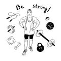 Muscular strong guy stands in the gym surrounded by sports items Royalty Free Stock Photo