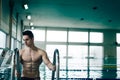 Muscular swimmer on the ladder Royalty Free Stock Photo