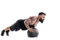 Muscular tattooed bearded male exercising fitness weights Medicine Ball push ups exercises in studio isolated on white Royalty Free Stock Photo