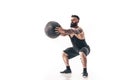 Muscular tattooed bearded male exercising fitness weights Medicine Ball in studio isolated on white background Royalty Free Stock Photo