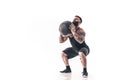 Muscular tattooed bearded male exercising fitness weights Medicine Ball in studio isolated on white background Royalty Free Stock Photo