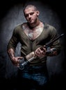 Muscular tattooed man with jackhammer