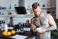Tattooed man holding bowl with breakfast Royalty Free Stock Photo