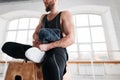 Perspiring fit athlete relaxing in sport gym after intense workout Royalty Free Stock Photo