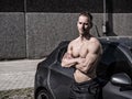 Muscular topless man outside of car Royalty Free Stock Photo