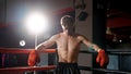 Muscular western boxer stood in corner of ring preparing to gain confidence and meditate to calm mind before fight. Man wearing Royalty Free Stock Photo