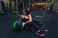 Muscular woman doing intense core workout in gym. Strong female doing core exercise on fitness mat with medicine ball in Royalty Free Stock Photo