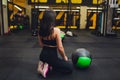 Muscular woman doing intense core workout in gym. Strong female doing core exercise on fitness mat with medicine ball in Royalty Free Stock Photo