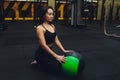 Muscular woman doing intense core workout in gym. Strong female doing core exercise on fitness mat with medicine ball in Royalty Free Stock Photo