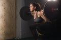 Muscular woman in a gym doing heavy weight exercises with barbell Royalty Free Stock Photo