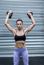 A muscular woman lifting kettlebells Royalty Free Stock Photo