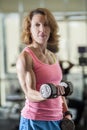 Muscular woman lifting weights Royalty Free Stock Photo