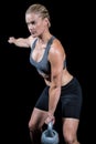 Muscular woman swinging heavy kettlebell Royalty Free Stock Photo