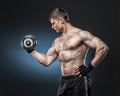 Muscular yong man exercising with dumbbell Royalty Free Stock Photo