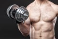 Muscular yong man exercising with dumbbell Royalty Free Stock Photo