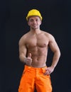 Muscular young construction worker doing thumb up sign for OK Royalty Free Stock Photo