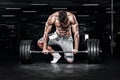 Muscular young fitness sports man workout with barbell in fitness gym Royalty Free Stock Photo