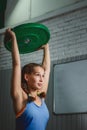 Muscular young fitness woman lifting a weight crossfit in the gym. Crossfit Royalty Free Stock Photo
