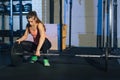 Muscular young fitness woman lifting a weight crossfit in the gym. Fitness woman deadlift barbell. The gym on the red Royalty Free Stock Photo