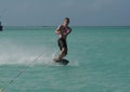 Muscular Young Guy Wakeboarding Off the Coast of Aruba Royalty Free Stock Photo
