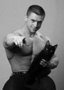 Muscular young man with cat