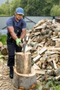 Muscular young man chopping logs Royalty Free Stock Photo