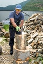 Muscular young man chopping logs Royalty Free Stock Photo