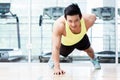 Muscular young man doing one armed pushups in gym Royalty Free Stock Photo