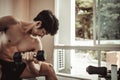 Muscular Young Man Exercising with Dumbbells in Gym - Strength Training and Fitness Concept Royalty Free Stock Photo