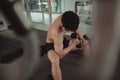 Muscular Young Man Exercising with Dumbbells in Gym - Strength Training and Fitness Concept Royalty Free Stock Photo