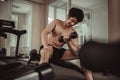 Muscular Young Man Exercising with Dumbbells in Gym - Strength Training and Fitness Concept Royalty Free Stock Photo