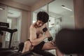 Muscular Young Man Exercising with Dumbbells in Gym - Strength Training and Fitness Concept Royalty Free Stock Photo