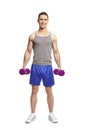 Muscular young man exercising in sports outfit Royalty Free Stock Photo