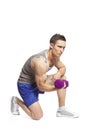 Muscular young man exercising in sports outfit Royalty Free Stock Photo