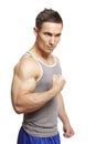 Muscular young man flexing arm muscles in sports outfit Royalty Free Stock Photo