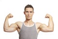 Muscular young man flexing arm muscles in sports outfit Royalty Free Stock Photo