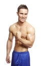 Muscular young man flexing arm muscles in sports outfit Royalty Free Stock Photo