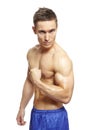 Muscular young man flexing arm muscles in sports outfit Royalty Free Stock Photo