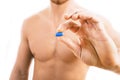 Muscular young man holding blue pill Royalty Free Stock Photo