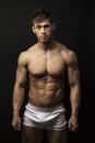 Muscular young man over black Royalty Free Stock Photo