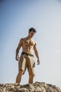 Muscular young man shirtless against the sky Royalty Free Stock Photo