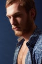 Profile of a man. A muscular young man wearing an open shirt and looking away. Royalty Free Stock Photo