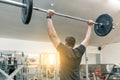 Muscular young man working with barbell heavy weights in training gym. Sport, bodybuilding, athlete, weightlifting, workout Royalty Free Stock Photo