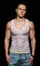 Muscular young man in the white wet t-shirt