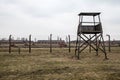 Museum Auschwitz - Birkenau, concentration camp barbed wire and guard tower in Oswiecim city. Royalty Free Stock Photo