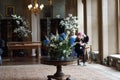 Museum ballroom with a central table and flowers inside the Belvoir Castle in Lincolnshire