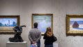 The Museum of Fine Arts, Boston, Massachusetts, United States of America - Vistiors looking at art works of Claude Monet. Royalty Free Stock Photo