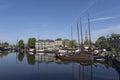 Museum harbor and Turfsingelgracht in Gouda with historic boats, De Roode Leeuw flour mill and the Gouwekerk Royalty Free Stock Photo