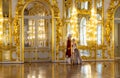 Museum workers in court costumes are waiting for visitors in the front hall with a golden finish